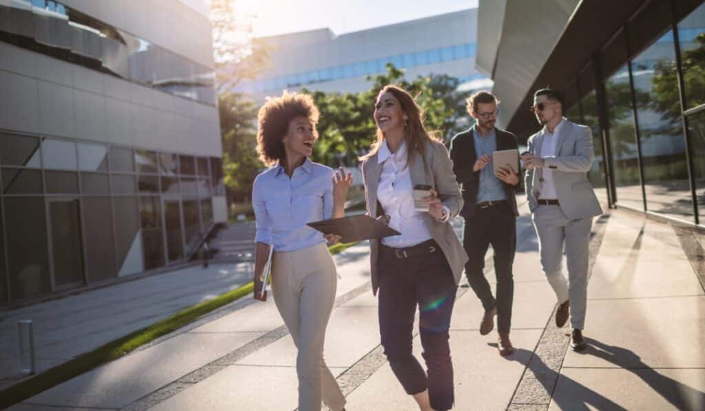 a group of people walking on a sidewalk