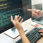 a hands pointing at a computer screen
