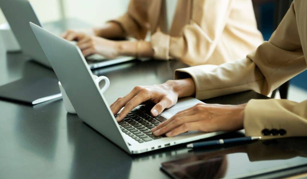 a close-up of hands on a laptop